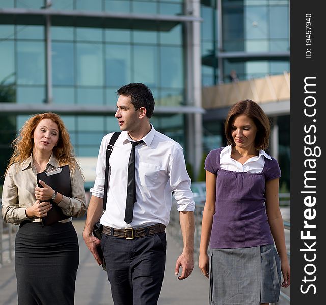 Group of workers walk across office building. Group of workers walk across office building