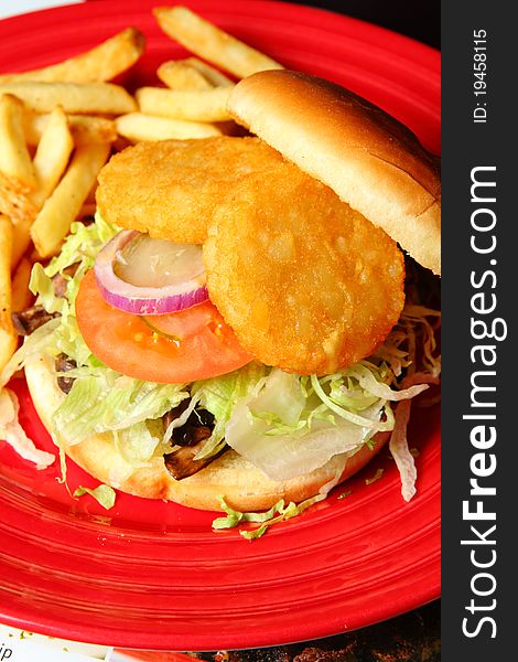 Sandwiches with onion, fried potato and tomato on a Red Plate. Sandwiches with onion, fried potato and tomato on a Red Plate