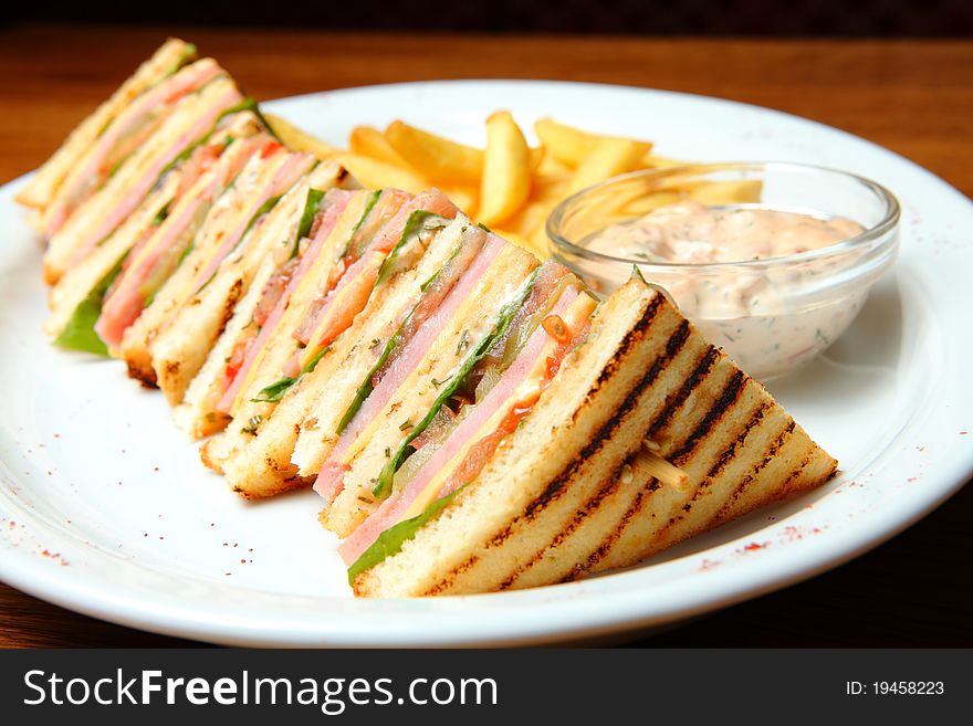 Sandwich with French Fries and sauce on a Plate. Sandwich with French Fries and sauce on a Plate