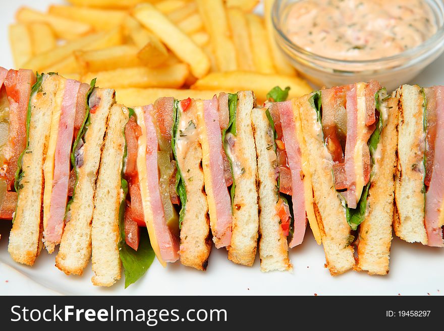 Sandwich with French Fries and sauce on a Plate. Sandwich with French Fries and sauce on a Plate