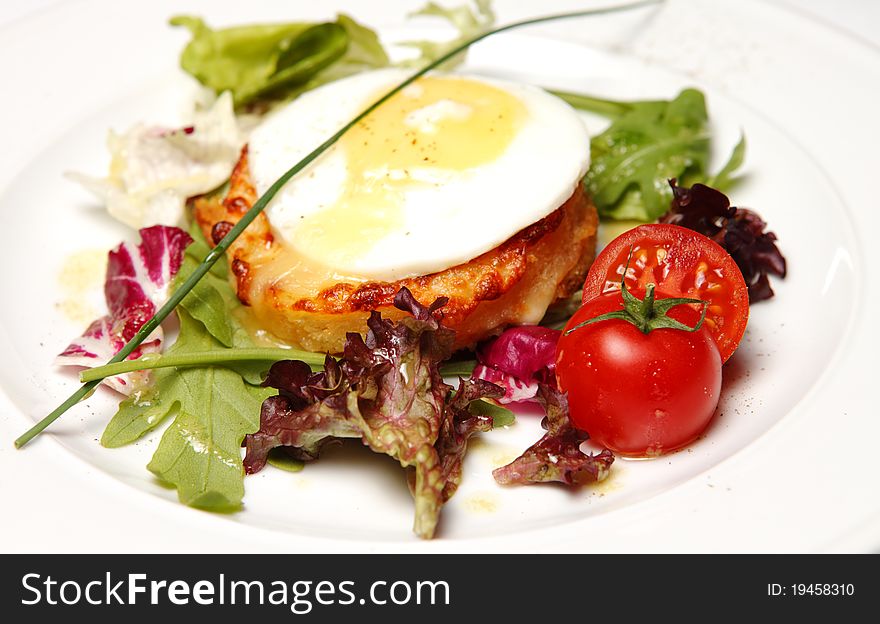 Sandwich on a Plate with french fries, tomato, cheese, bacon and egg