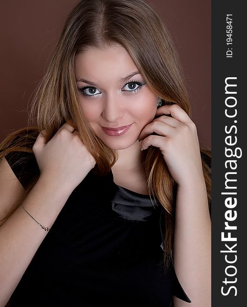 Portrait of a beautiful young woman with long hair, studio shot