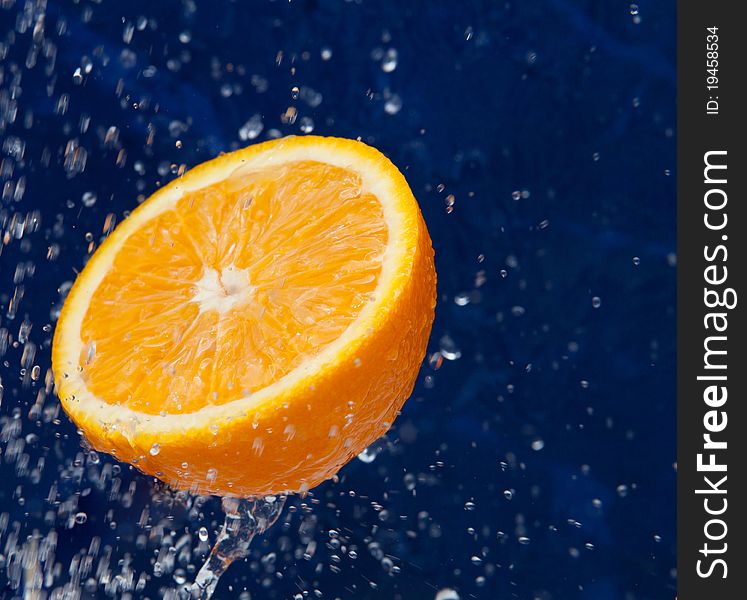 Fresh sweet orange under drops of water. Fresh sweet orange under drops of water