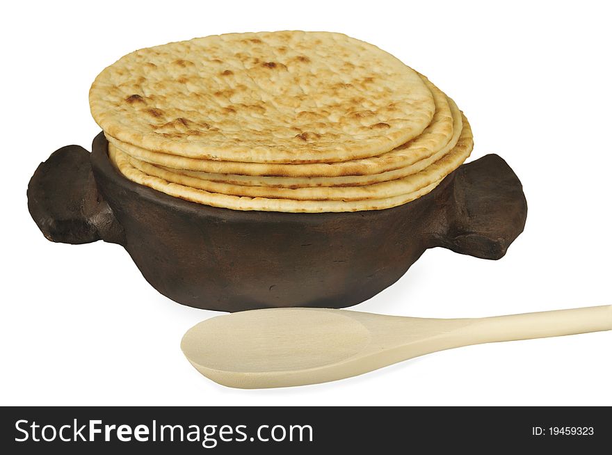 Fried fritters on a frying pan on the white isolated background. Fried fritters on a frying pan on the white isolated background