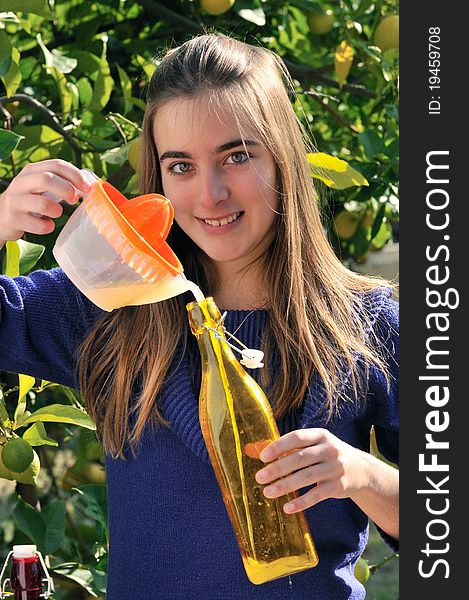 Girl making natural lemonade at garden