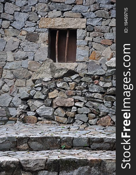 Small window attached on stone wall and stone steps, shown as featured architecture of mountaineer, and special color and texture. Small window attached on stone wall and stone steps, shown as featured architecture of mountaineer, and special color and texture.
