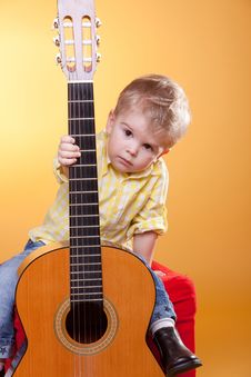 Child Proposing Play The Guitar Stock Photo