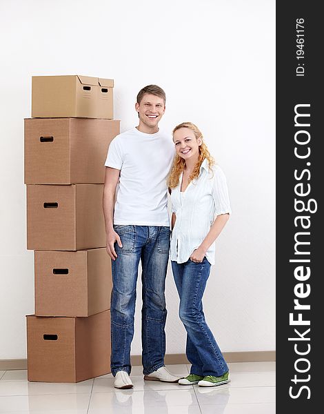 Young couple with boxes indoors. Young couple with boxes indoors