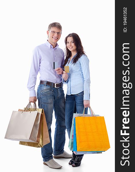 Young couple with credit cards and shopping on a white background