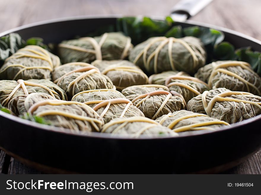 Rustic food, armenian or greek dolmades wrapped with rhubarb leaves, meat and rice. Rustic food, armenian or greek dolmades wrapped with rhubarb leaves, meat and rice