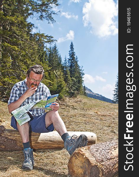 Senior man hiking in beautiful nature surrounding with big mountains in the back. Senior man hiking in beautiful nature surrounding with big mountains in the back.