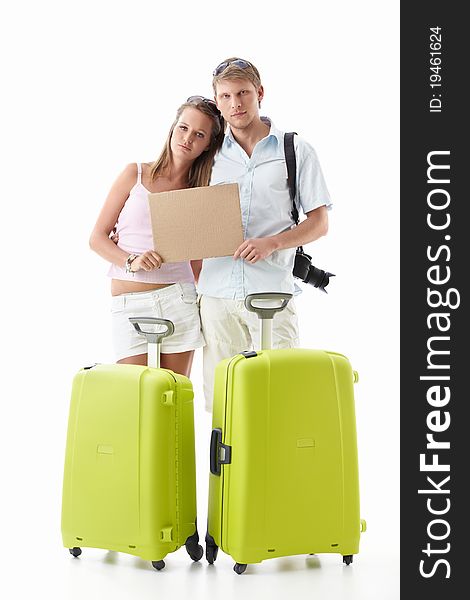 Upset couple with suitcases and empty sign on white background. Upset couple with suitcases and empty sign on white background