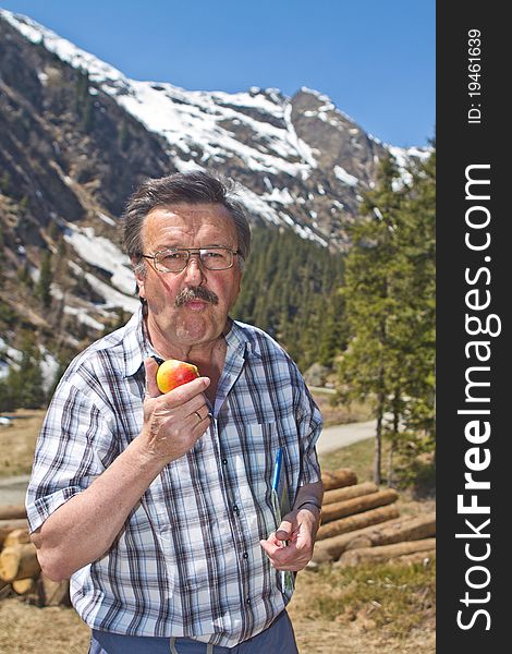 Retired man hiking in the alps