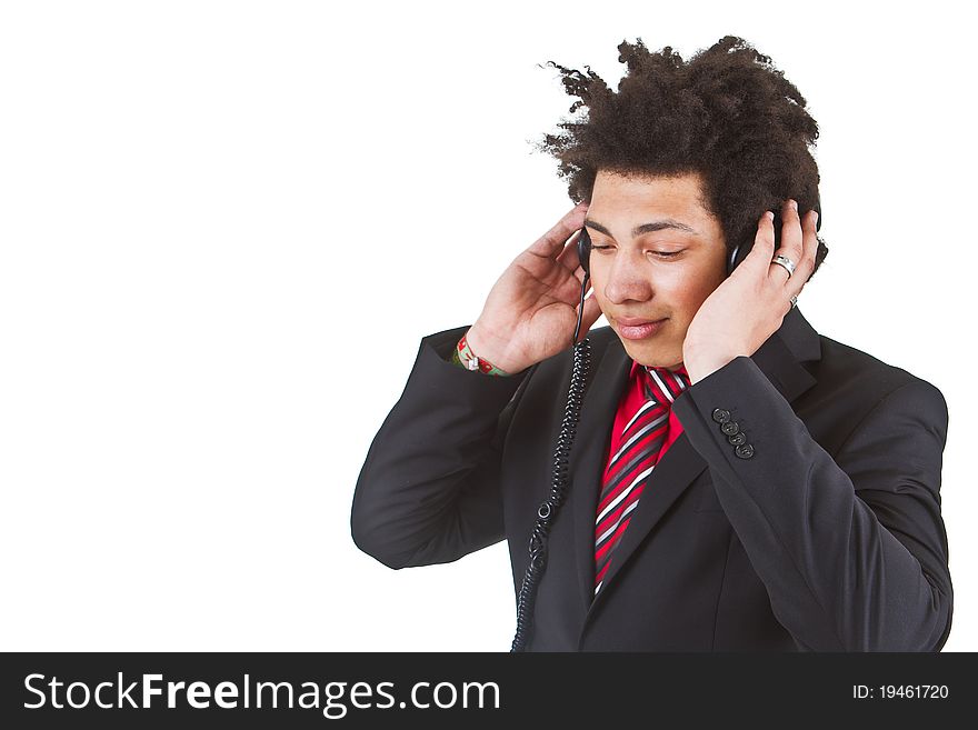 Young afro american business man with headphones listening to music. Isolated over white. Young afro american business man with headphones listening to music. Isolated over white.