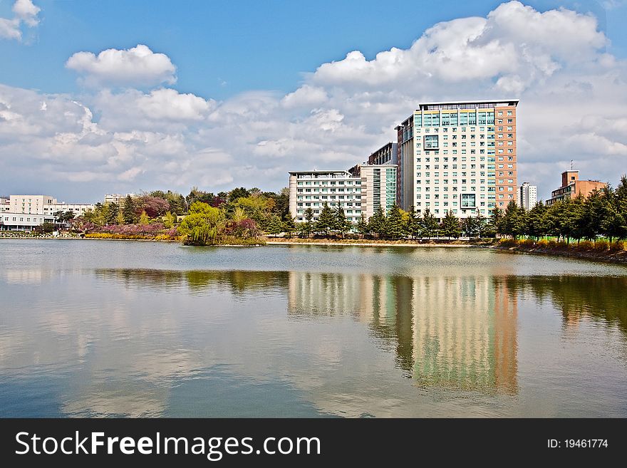 Modern apartment buildings over lake in a university campus