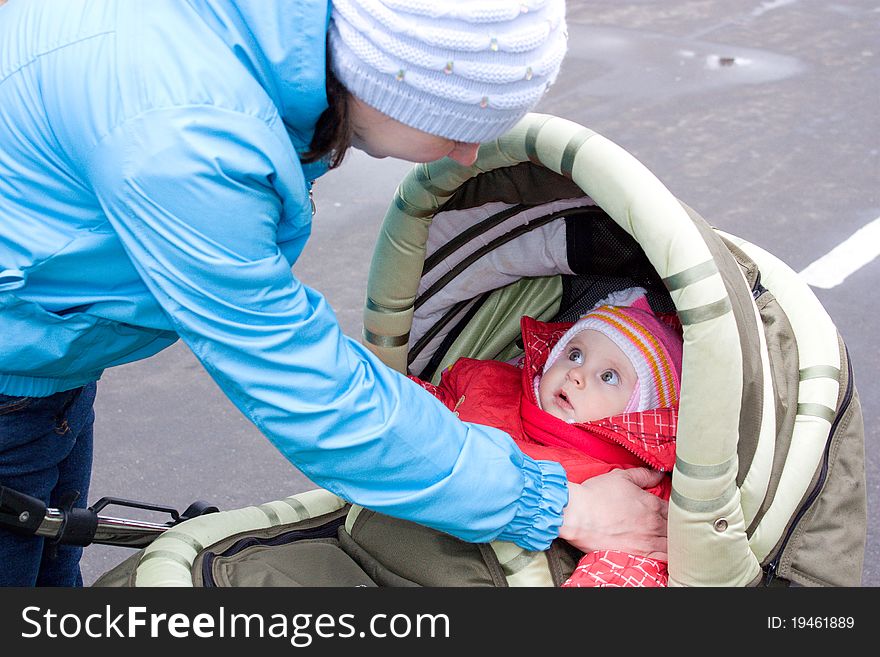A woman with a baby in a stroller.