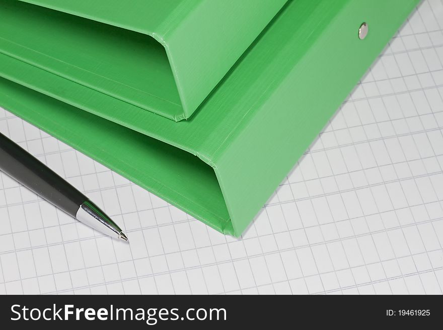 Green business folders with pen on accounting paper. Green business folders with pen on accounting paper