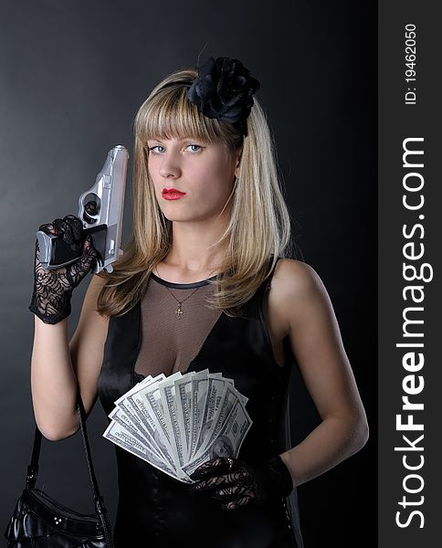 Gangster woman with pistol in black