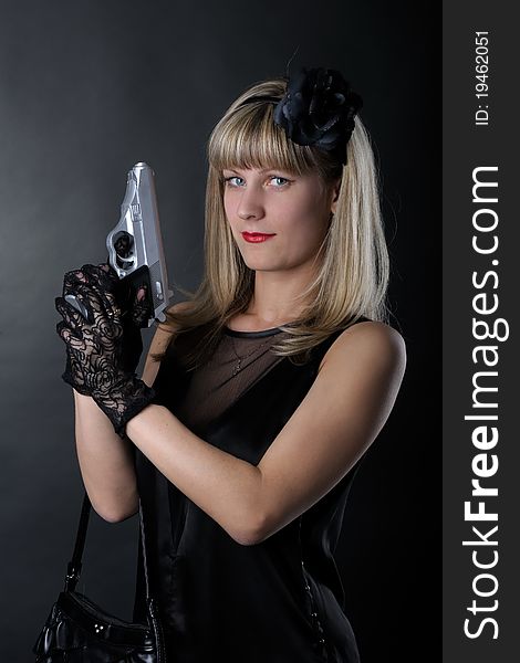Gangster woman with pistol in black