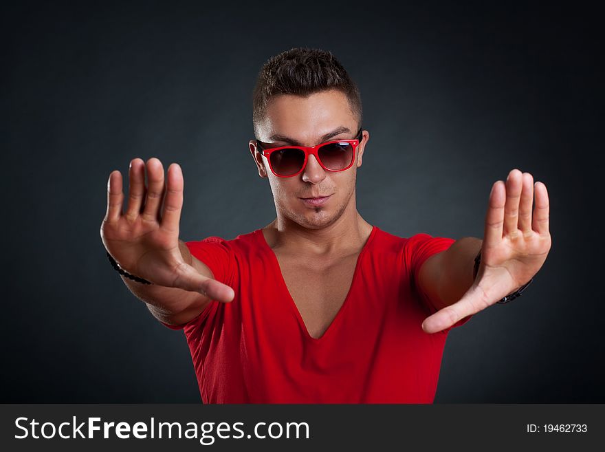 Handsome man making a stop sign with his hands, isolated