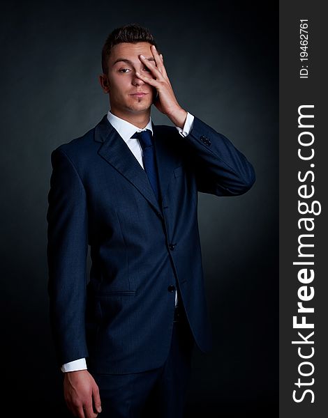 Portrait of handsome stylish man in elegant blue suit