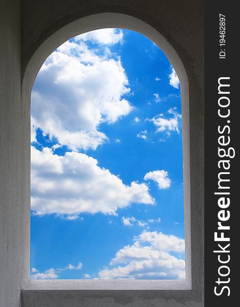 Window frame exposing blue sky and white clouds. Window frame exposing blue sky and white clouds