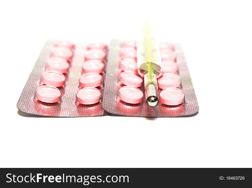 Photo of the Thermometer and pills on white background