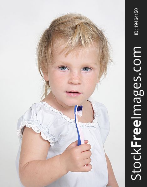 Cute child with toothbrush over white