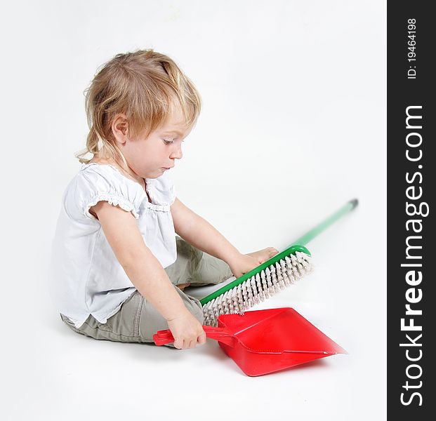 Cute child with dustpan and brush