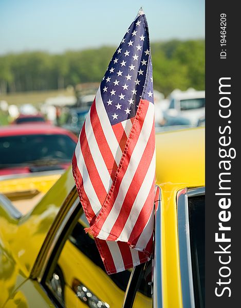 United states stars and stripes flag hanging from a vehicle door. United states stars and stripes flag hanging from a vehicle door