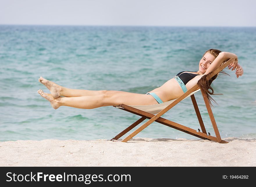 Young happy woman relaxing on beach
