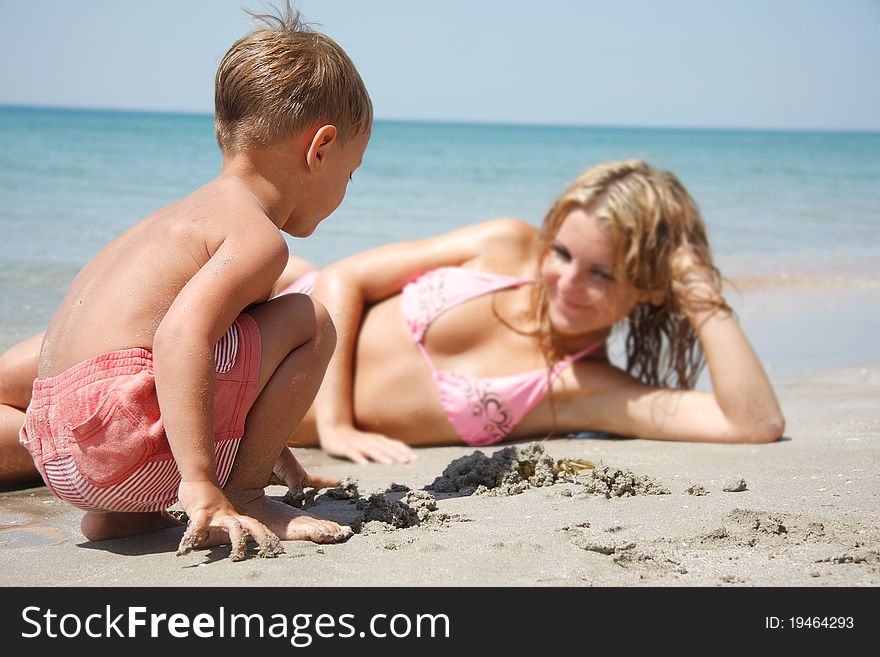 Mother and son playing on beach. Mother and son playing on beach