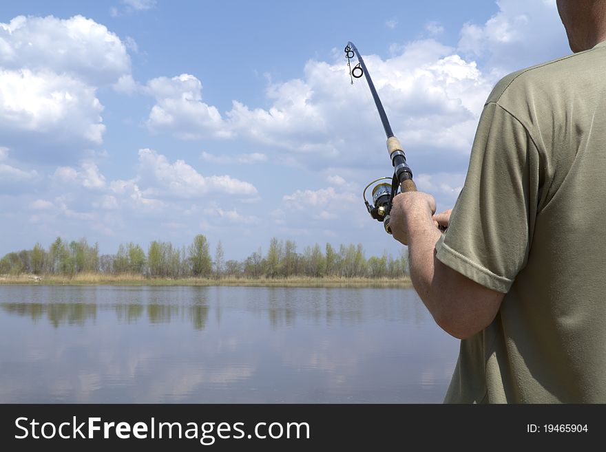 Fishing on the lake. angler keeps spinning in my hand. Fishing on the lake. angler keeps spinning in my hand