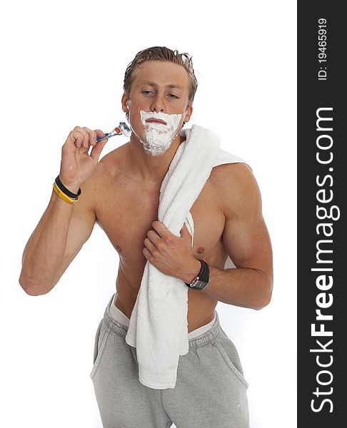 Image of young male shaving against white. Image of young male shaving against white