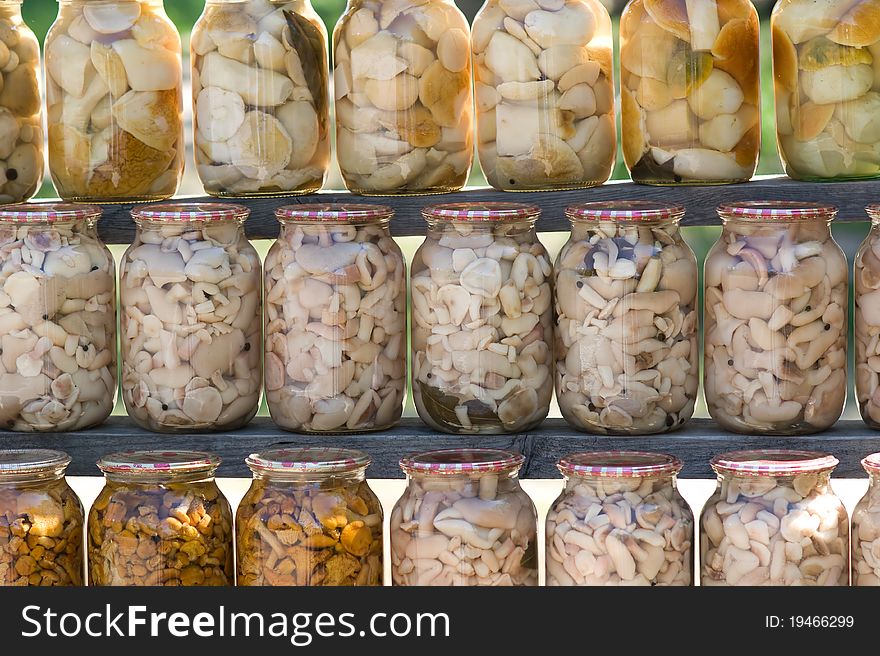 Homemade canned different mushrooms in glass banks. Homemade canned different mushrooms in glass banks