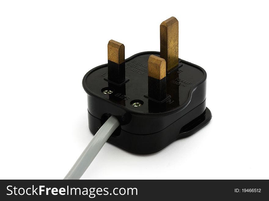 Black UK plug with a grey flex isolated over white. Black UK plug with a grey flex isolated over white