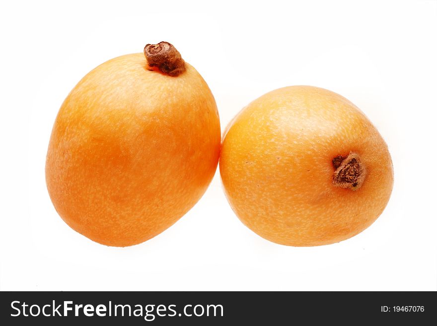 Two loquat fruits on white.