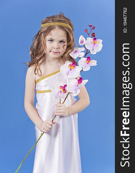 Beautiful girl in the dress of the goddess holding a flower