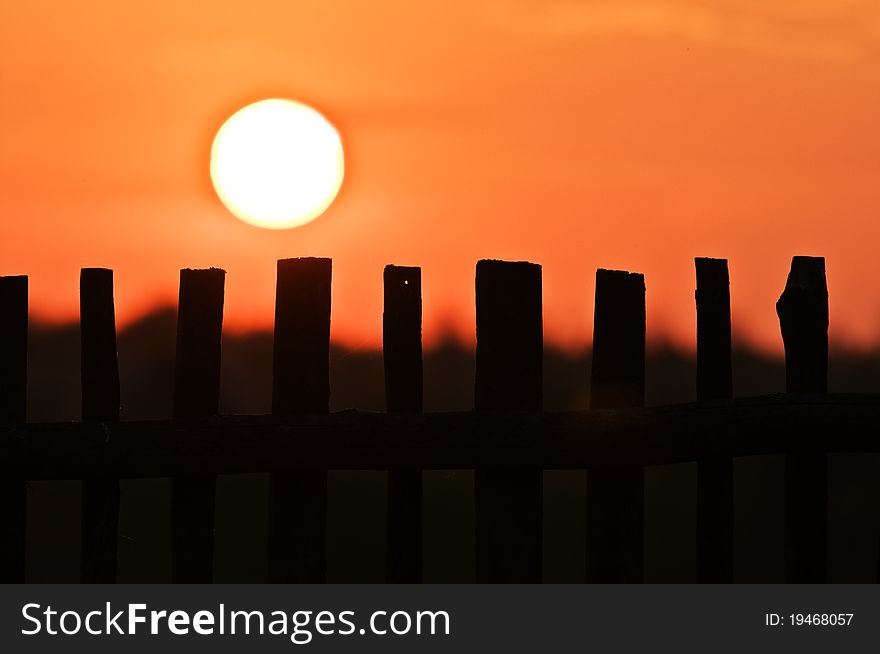 Fence silhouette and sun landscape