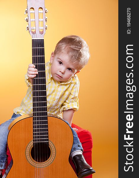 Child Proposing Play The Guitar