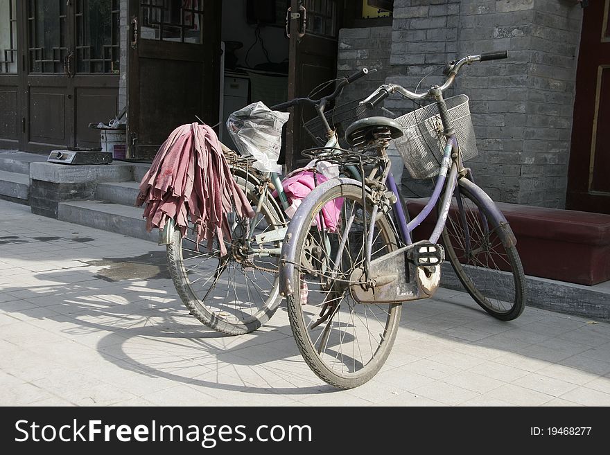 Two Chinese bicycles parked in a Beijing street