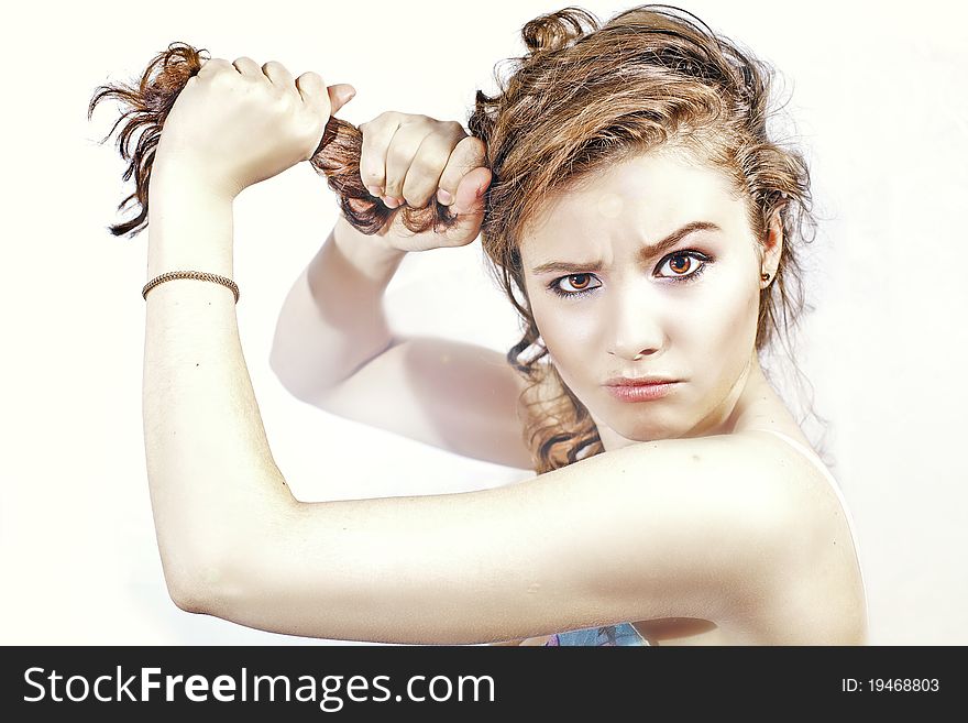 Brunette woman pulling her hair. Brunette woman pulling her hair