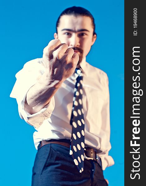 Businessman Shows His Fist On Blue Background