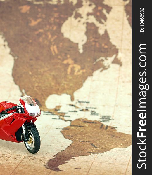 Red motorcycle in front of a world map. Red motorcycle in front of a world map