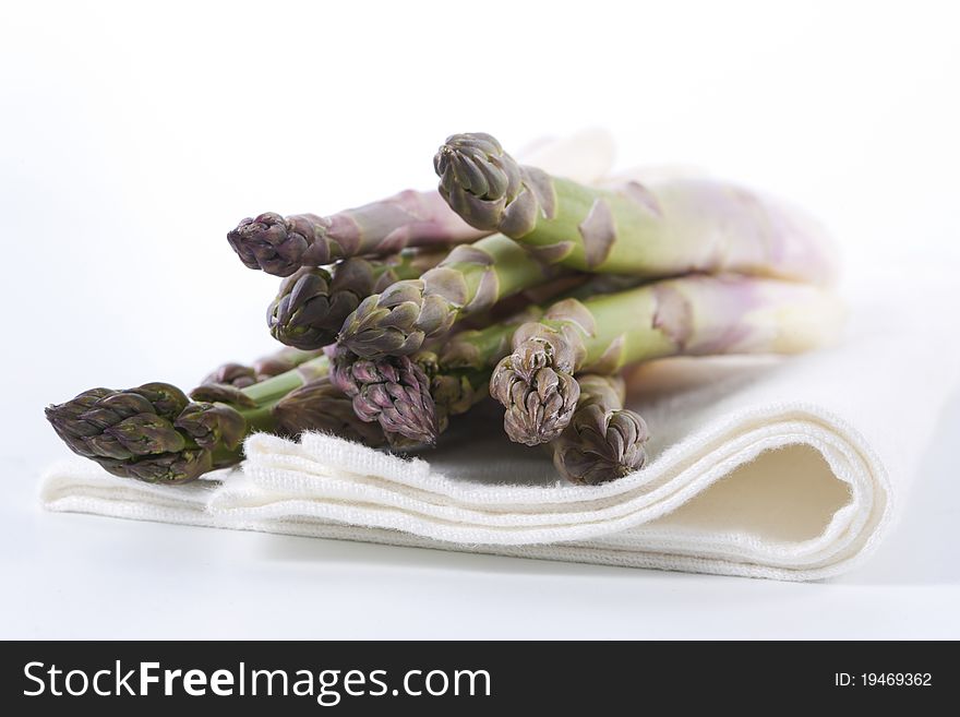 Raw asparagus on a white background