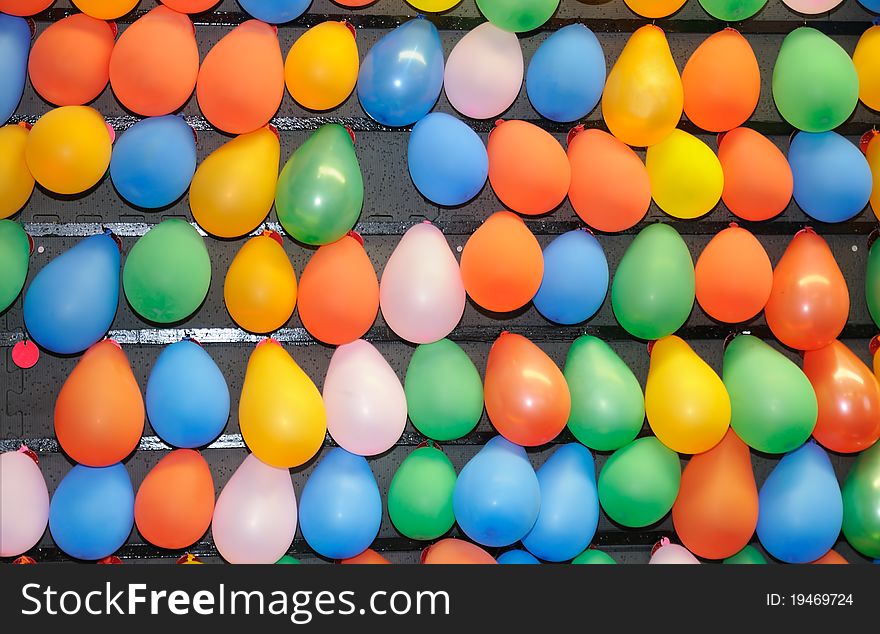 Many colorful balloons of various colors fo a background.