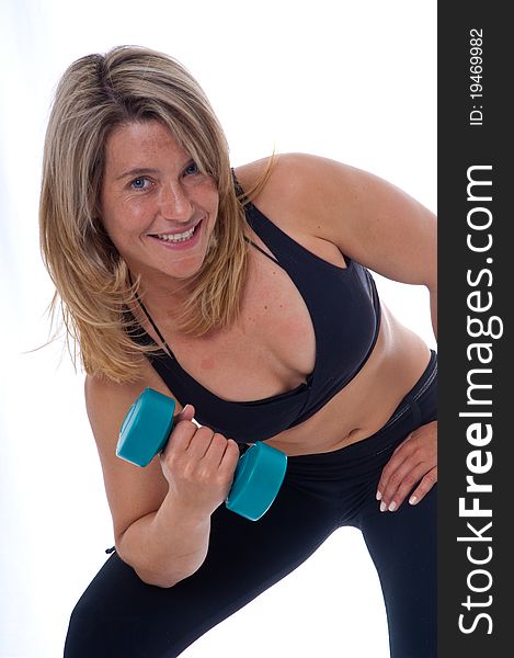 Active Woman doing exercises with dumbels