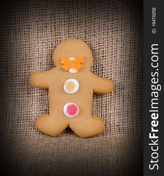 A Ginger Bread Man on a hessian background in a low light environment. A Ginger Bread Man on a hessian background in a low light environment.