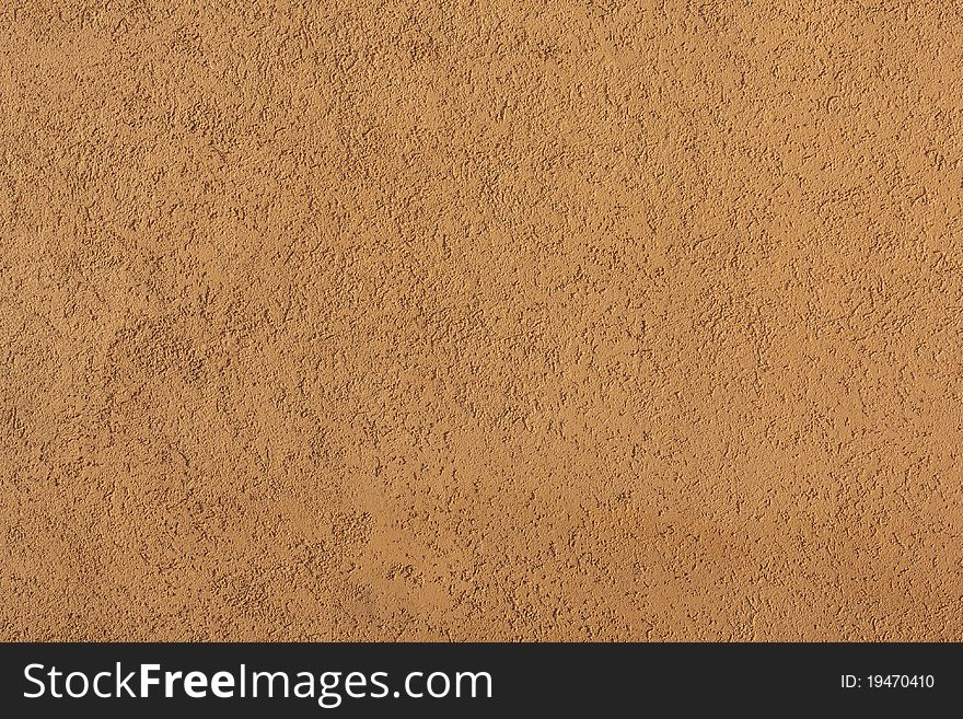 Close-up of yellow concrete wall illuminated by sunlight