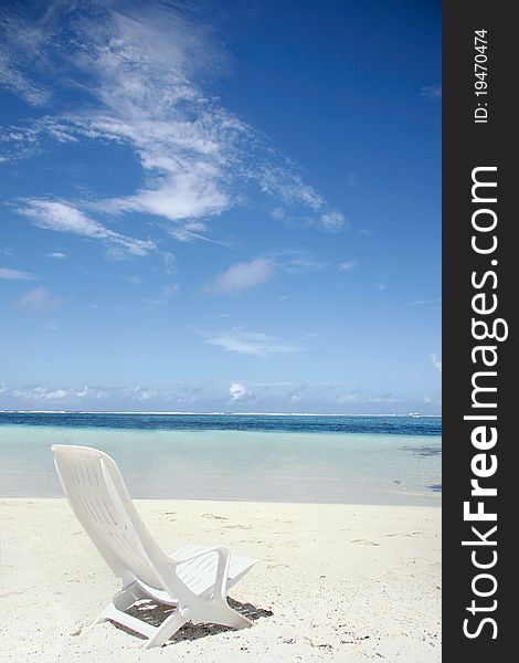 Chaise longue on empty beach under blue sky. Chaise longue on empty beach under blue sky